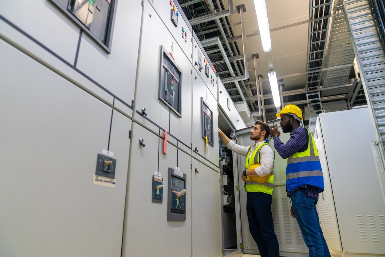 Electrician performing commercial electrical maintenance to improve safety in a Los Angeles business.